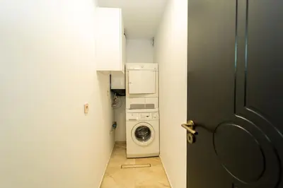 a laundry room with a washing machine and a washer at Lux Apart Karlovo in Karlovo