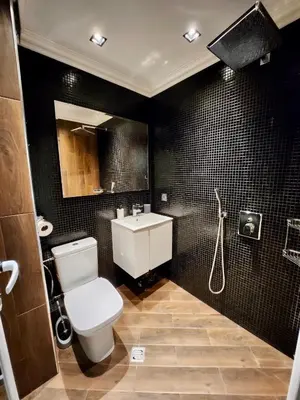 a bathroom with a white toilet and a sink at Joy Station Cozy Studio in Sofia