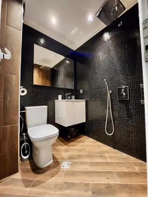 a bathroom with a toilet and a sink and a shower at Joy Station Cozy Studio in Sofia