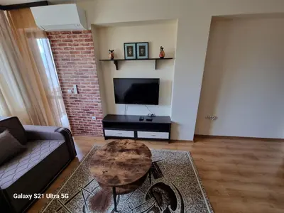 a living room with a couch and a coffee table at Suite Roma 2 at Spa Club Bor in Velingrad