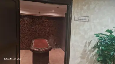 a bathroom with a toilet with a brick wall at Suite Roma 2 at Spa Club Bor in Velingrad