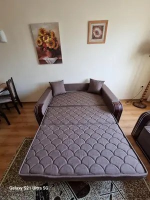 a large couch in a living room with at Suite Roma 2 at Spa Club Bor in Velingrad