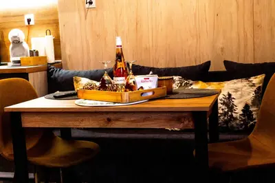 a table with a bottle of beer and a box on it at Premium mountain studio 40 Semiramida Gardens in Borovets