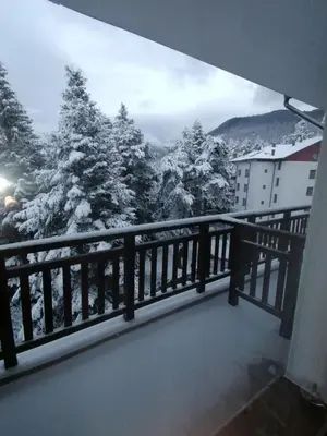 a balcony with a view of snow covered trees at Premium mountain studio 40 Semiramida Gardens in Borovets