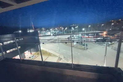 a view of a parking lot at night at Елегантен градски апартамент с обширна тераса in Pernik