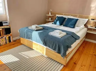 a bedroom with a large bed with blue pillows at Cozy & Boho Top Center Apartment in Sofia