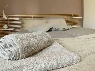 a white bed with a blanket on top of it at Cozy & Boho Top Center Apartment in Sofia