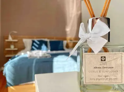 a glass bottle with a bow on a table with a bed at Cozy & Boho Top Center Apartment in Sofia