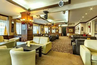 a lobby with couches and chairs and a waiting room at Dino privates apartments Emerald in Bansko