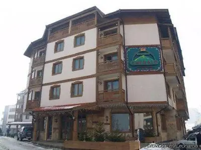 a tall building with a sign on the side of it at Dino privates apartments Emerald in Bansko