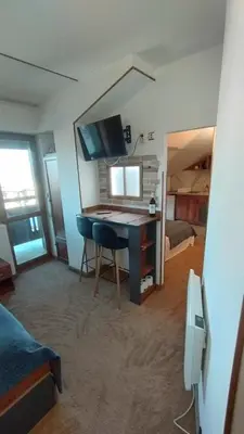 a room with a desk with a computer and a bed at Dino privates apartments Emerald in Bansko