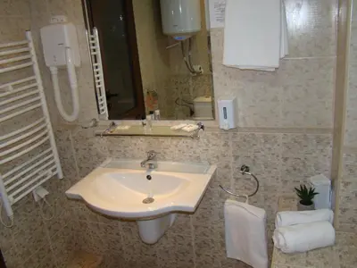 a bathroom with a sink and a mirror at Dino privates apartments Emerald in Bansko