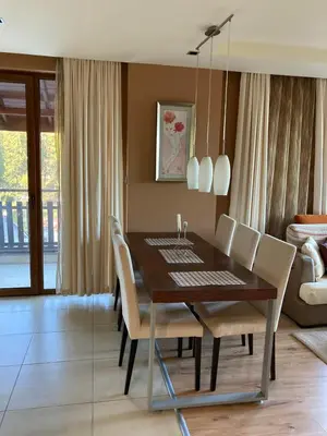a dining room with a table and chairs at Апартамент за гости Свети Трифон in Pamporovo