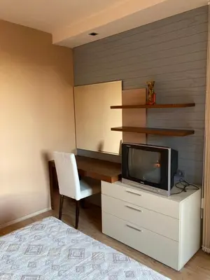 a room with a desk with a tv and a chair at Апартамент за гости Свети Трифон in Pamporovo