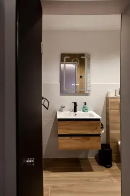 a bathroom with a sink and a mirror at Very Spacious & Modern 3Bed near Airport & Centre in Sofia