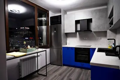 a kitchen with blue cabinets and a view of a city at Very Spacious & Modern 3Bed near Airport & Centre in Sofia