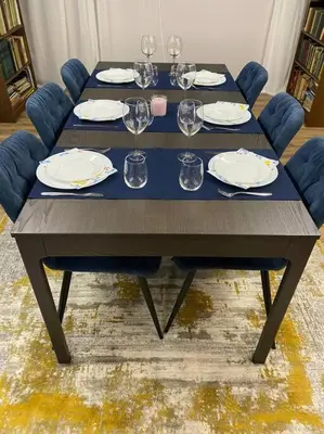 a table with plates and wine glasses on it at Very Spacious & Modern 3Bed near Airport & Centre in Sofia