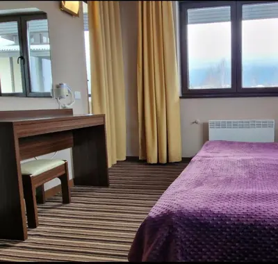 a room with a bed and a desk and a mirror at Apartaments by Zenit in Terra Complex B16 and D09 near Bansko in Razlog