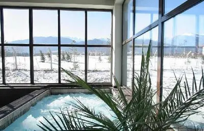 a room with a jacuzzi tub in a building with snow at Apartaments by Zenit in Terra Complex B16 and D09 near Bansko in Razlog