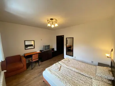 a bedroom with a bed and a desk and a chair at House Trivia in Bansko