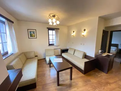 a living room with two couches and a table at House Trivia in Bansko