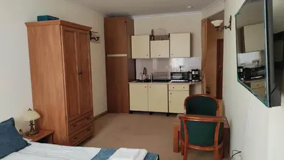 a small room with a bed and a kitchen at Annett apartments at Emerald hotel in Bansko