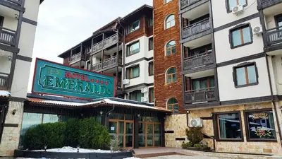 a building with a sign for a hotel at Annett apartments at Emerald hotel in Bansko