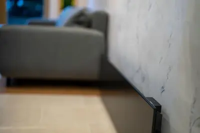 a couch in a room with a cord plugged into a wall at Stylish Cozy Studio with fireplace in Bansko