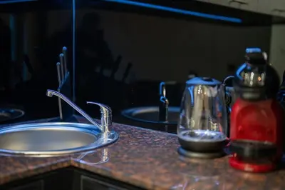 a kitchen counter with a sink and a mixer at Stylish Cozy Studio with fireplace in Bansko