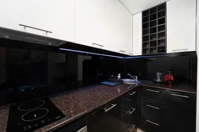 a black and white kitchen with a counter top at Stylish Cozy Studio with fireplace in Bansko