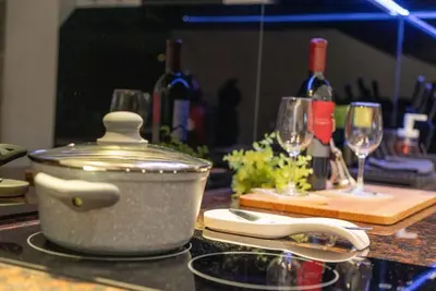 a pot on a counter with wine glasses and wine bottles at Stylish Cozy Studio with fireplace in Bansko