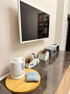 a kitchen counter with a toaster and a tv on it at City centre stylish apartament with private backyard in Sofia