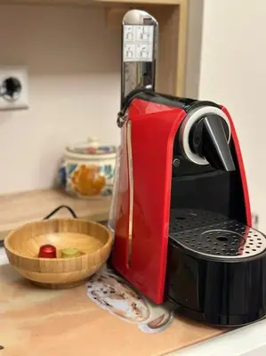 a toaster sitting on a counter next to a bowl of fruit at City centre stylish apartament with private backyard in Sofia