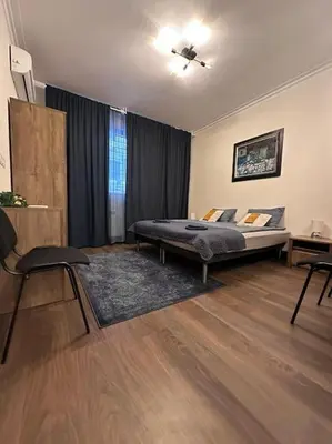 a bedroom with a bed and a chair in it at City centre stylish apartament with private backyard in Sofia