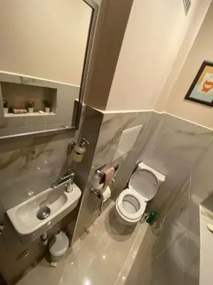 a small bathroom with a toilet and a sink at City centre stylish apartament with private backyard in Sofia