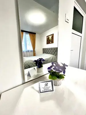 a room with a mirror and a table with flowers at Bóris House in Ognyanovo