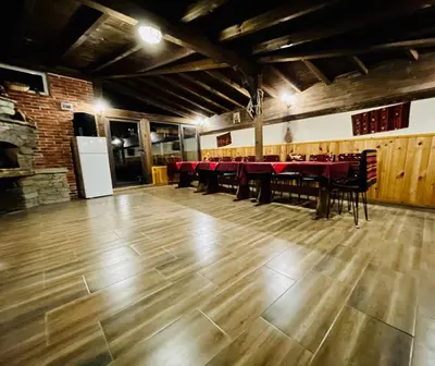a dining room with a red table and chairs at Bóris House in Ognyanovo