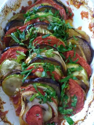 a plate of food with meat and vegetables on it at Парк хотел Кюстендил in Kyustendil