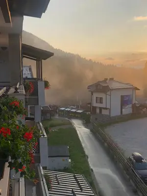 a view of a street with a house and a car at Luxury Apartments Studenets in Pamporovo
