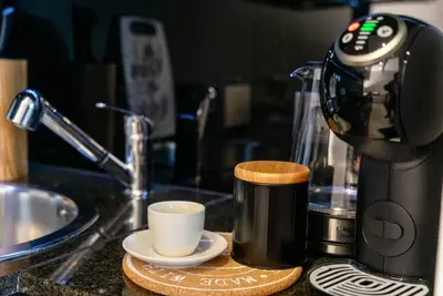 a coffee maker and a cup sitting on a counter at Warm&Cozy Studio with Patio in Bansko