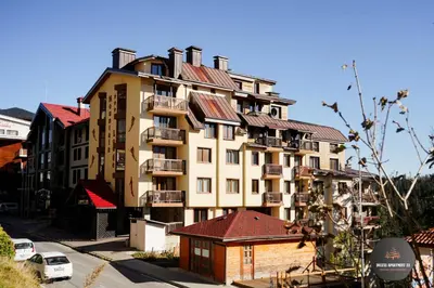 a large apartment building with a lot of windows at Deluxe Apartment 33 Mountain Lodge Pamporovo in Pamporovo