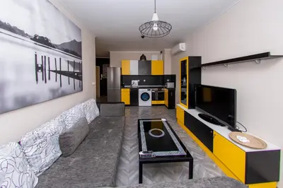 a living room with a couch and a tv at The yellow appartment in Sofia
