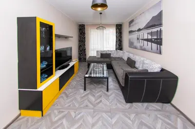 a living room with a couch and a tv at The yellow appartment in Sofia