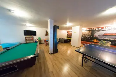 a room with a pool table and a living room at Форест Нук - апартамент in Pamporovo