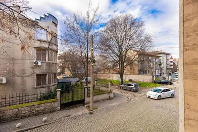a white car parked on a street next to a building at Dufti Home in Plovdiv Center & Old Town / Kapana in Plovdiv