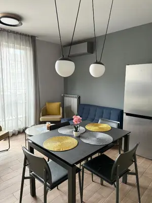 a living room with a black table and chairs at 7th Sense boutique apartments in Sofia