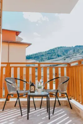 a patio with two chairs and a table on a balcony at Katerina Apartments 2 in Velingrad