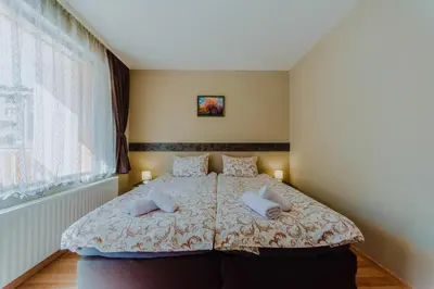 a bedroom with a bed with two pillows on it at Katerina Apartments 2 in Velingrad