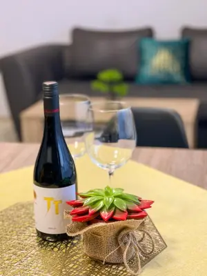 a bottle of wine and a glass on a table at Katerina Apartments 2 in Velingrad