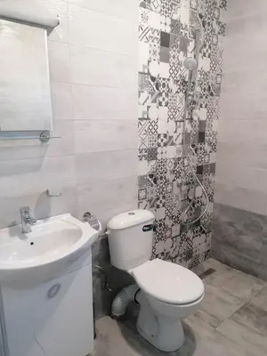 a bathroom with a toilet and a sink at Къща за гости Елит (Guest House Elite) in Sapareva Banya